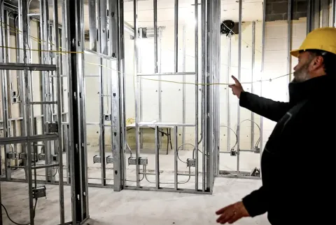 Ovation Director Dominic Cochran points out the framing for the Lansing Pubic Media Center recording studio